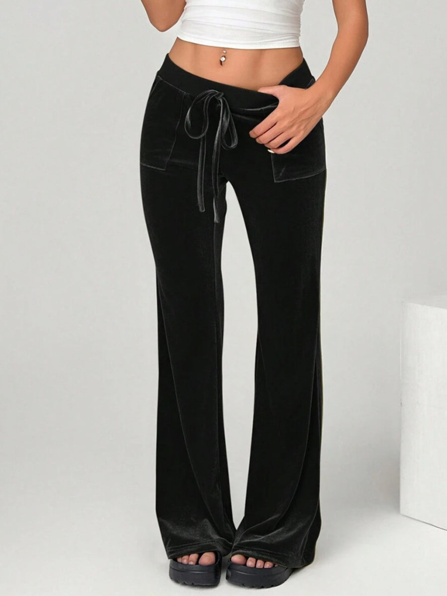 Black wide-leg pants worn by a person on a white background
