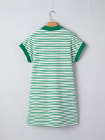 Green and white striped dress on a hanger against a light gray background