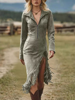 Woman wearing a green suede dress with fringe details in a natural setting
