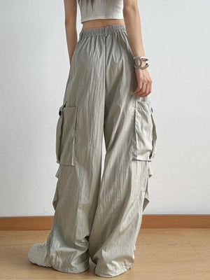 Person wearing beige cargo pants on a plain background