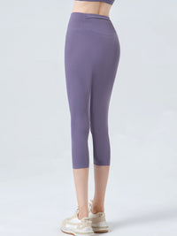 Purple leggings worn by a person on a white background
