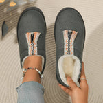 Gray slippers with decorative sole on a textured surface