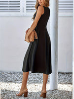 Woman wearing a black sleeveless dress with a white background