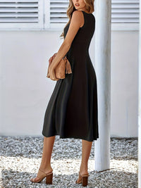 Woman wearing a black sleeveless dress with a white background