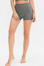 Person wearing gray high-waisted shorts on a white background