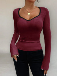 Maroon ribbed long-sleeve top worn by a person on a plain background