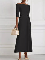 Woman wearing a black off-shoulder dress with a white background