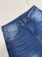 Blue denim shorts on a white background