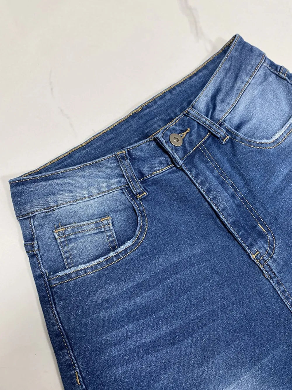 Blue denim shorts on a white background