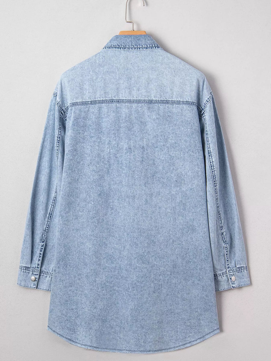Light blue denim shirt on a hanger against a white background