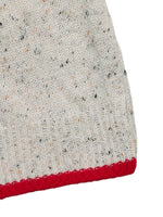 Close-up of a textured fabric with a red border on a white background
