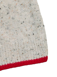 Close-up of a textured fabric with a red border on a white background