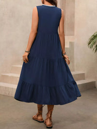Woman wearing a blue dress with a neutral background