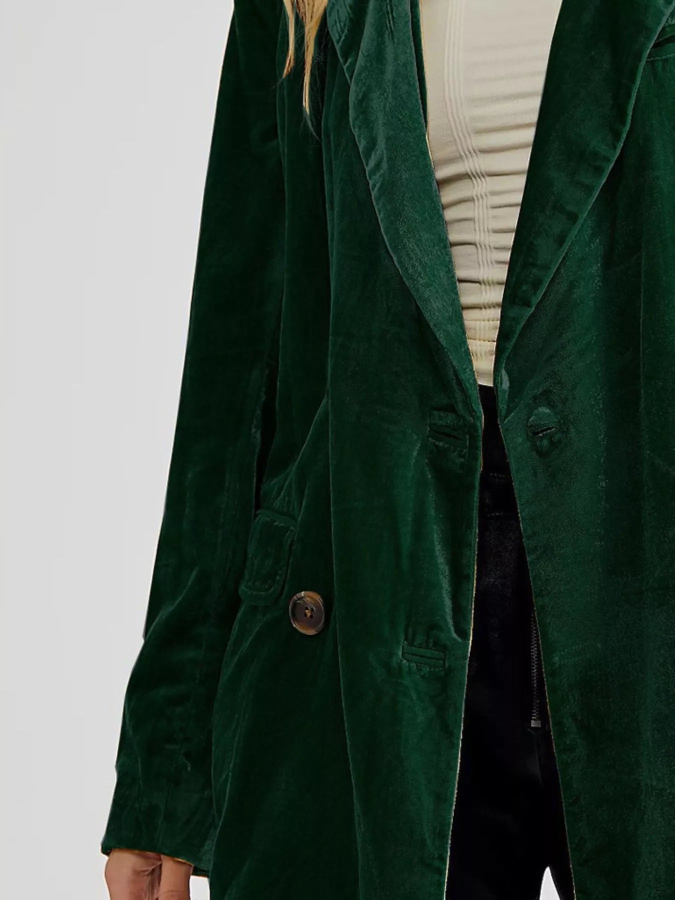 Green coat worn by a person on a light gray background