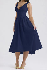 Navy blue dress worn by a person on a white background