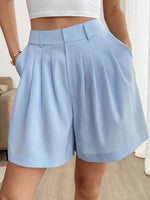 Light blue shorts worn by a person indoors.