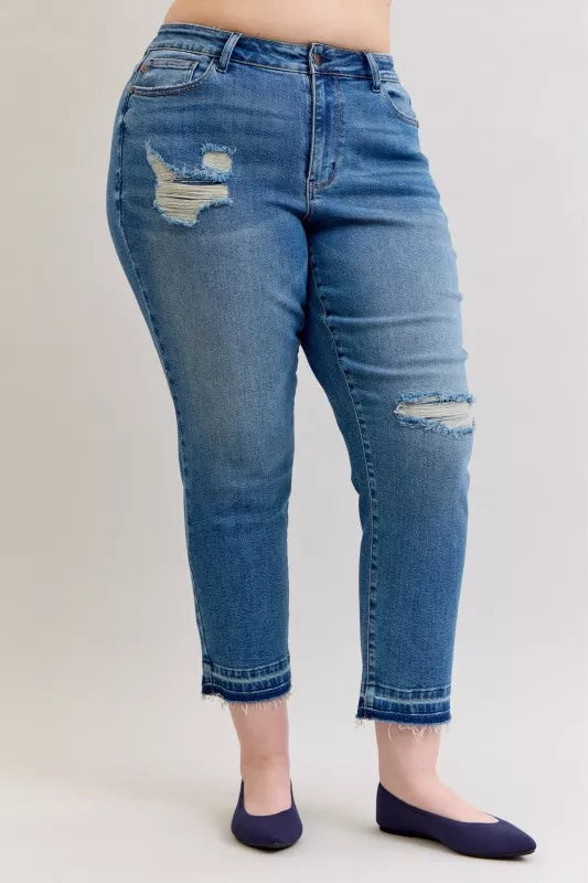 Blue jeans with distressing on a plain background