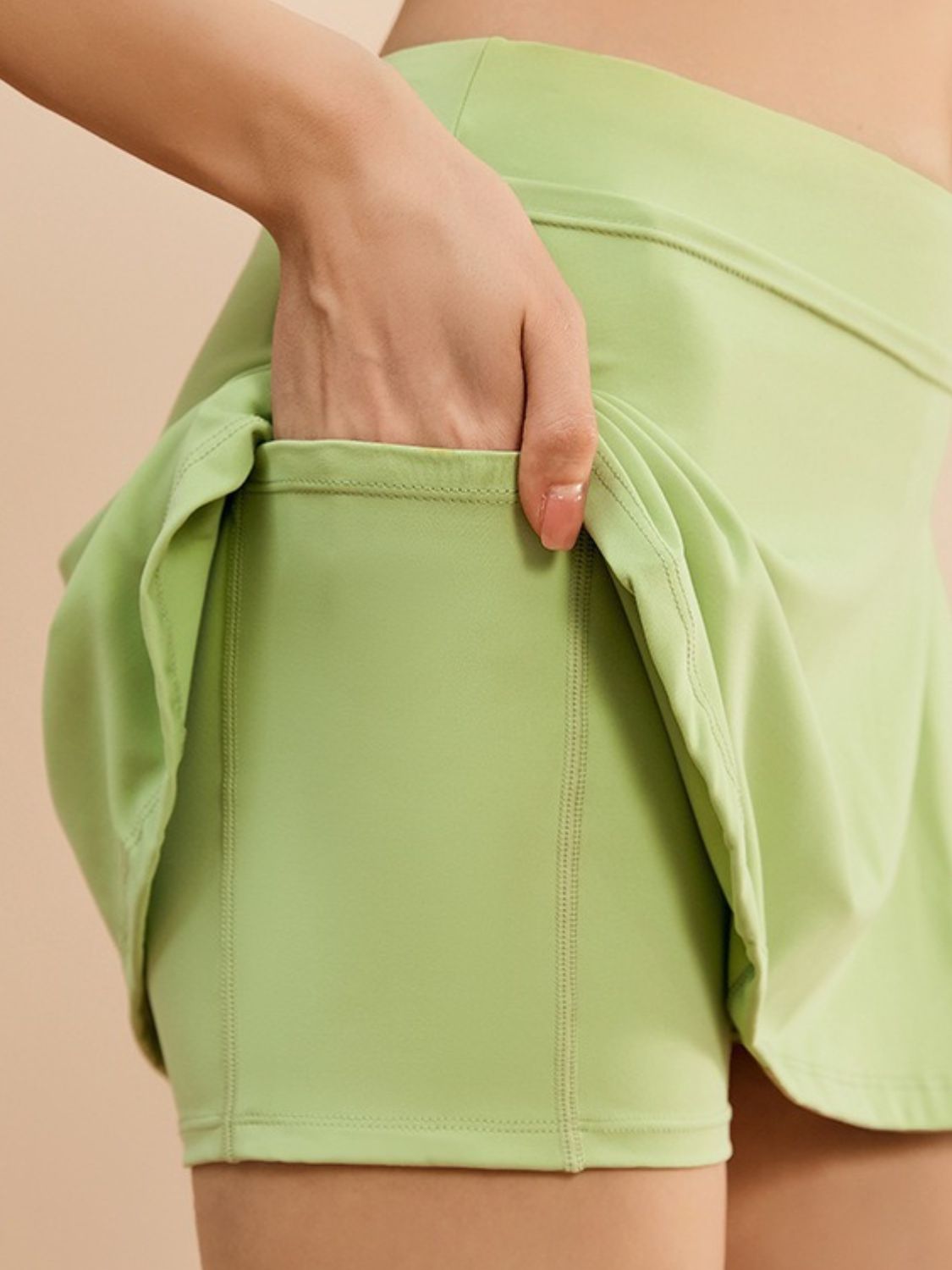 View of pocket on green High Waist Active Skort with Pockets