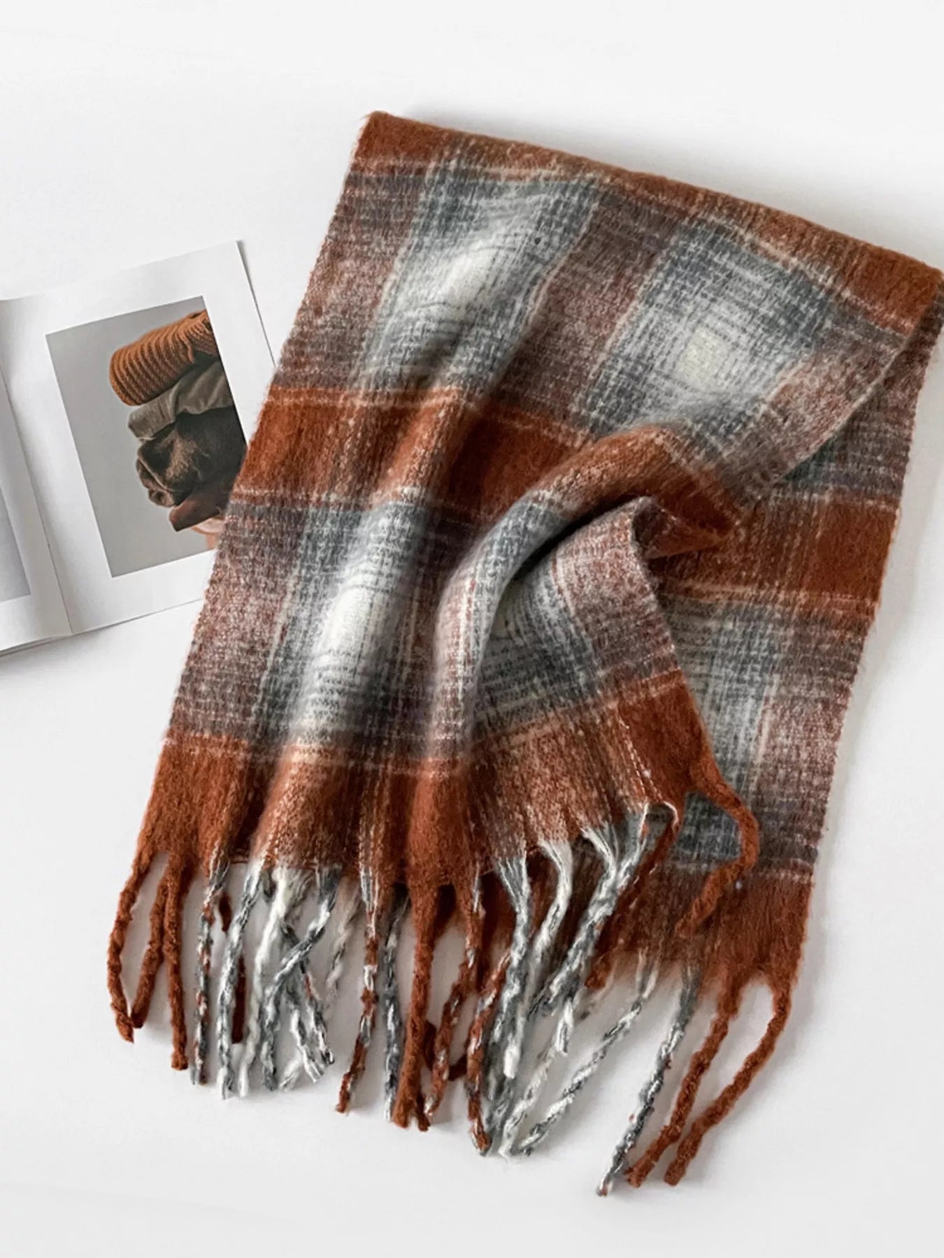 Plaid scarf with brown, gray, and white colors on a white background