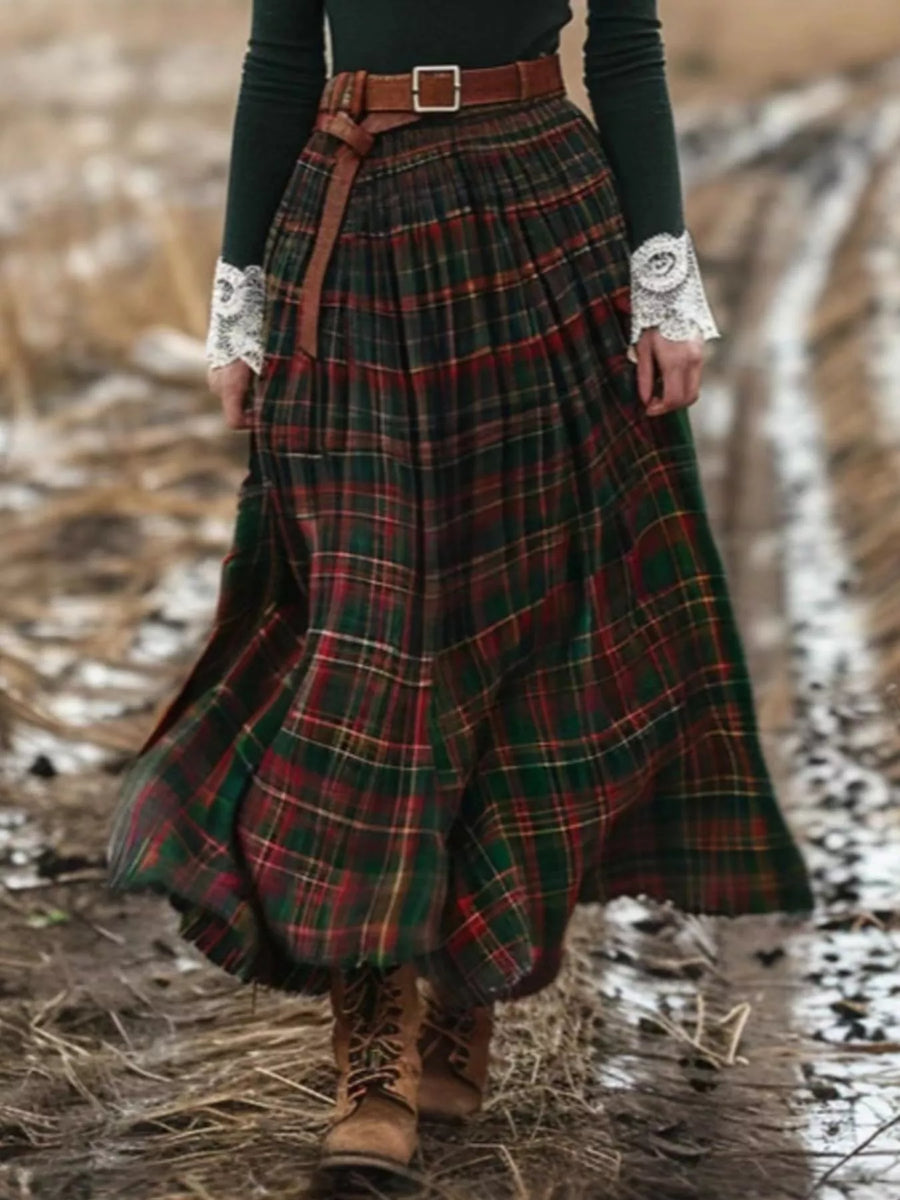 Person wearing a plaid skirt with a belt in a natural setting