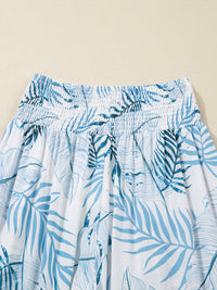 Blue leaf patterned pants on a beige background