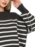 Black and white striped sweater with a close-up of the sleeve.