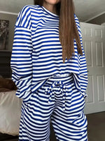 Person wearing a blue and white striped outfit in a room.
