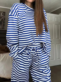 Person wearing a blue and white striped outfit in a room.