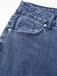 Close-up of blue denim jeans with a focus on the pocket area.