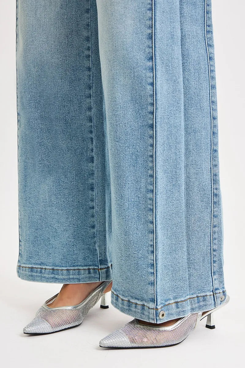 Light blue jeans with silver high-heeled shoes on a white background