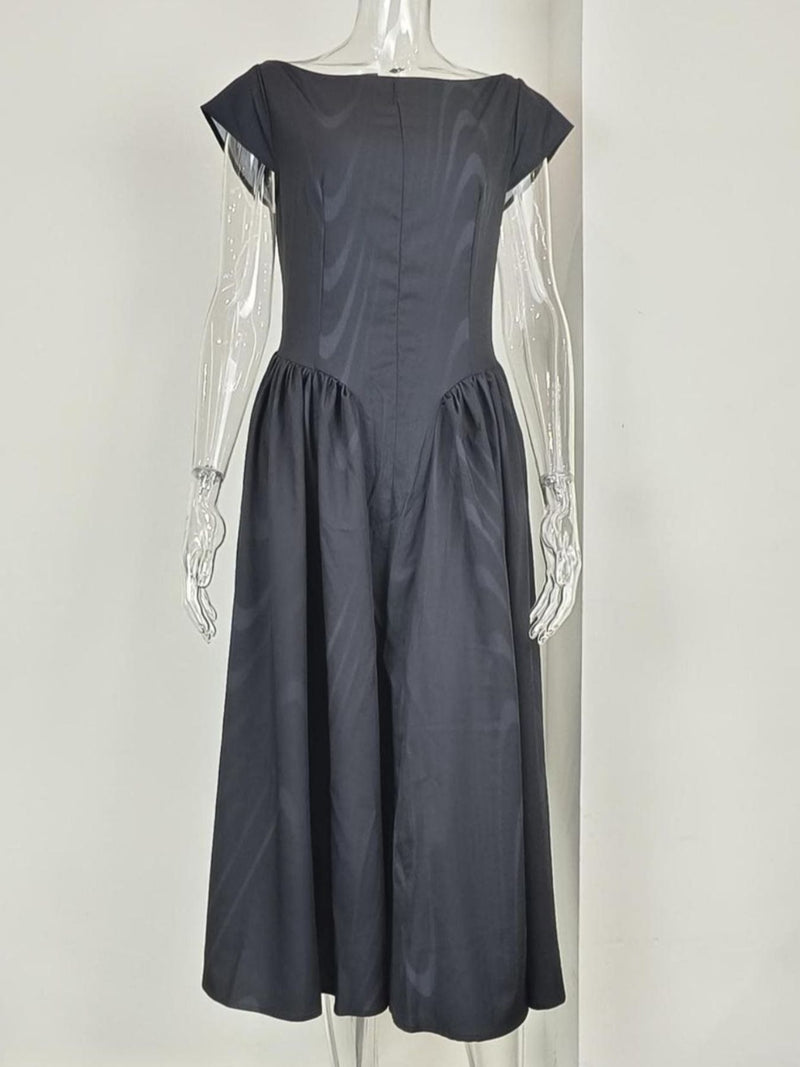 Dark gray dress on a mannequin against a white background