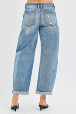 Blue jeans worn by a person on a white background