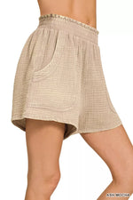 Beige shorts with a subtle pattern on a white background