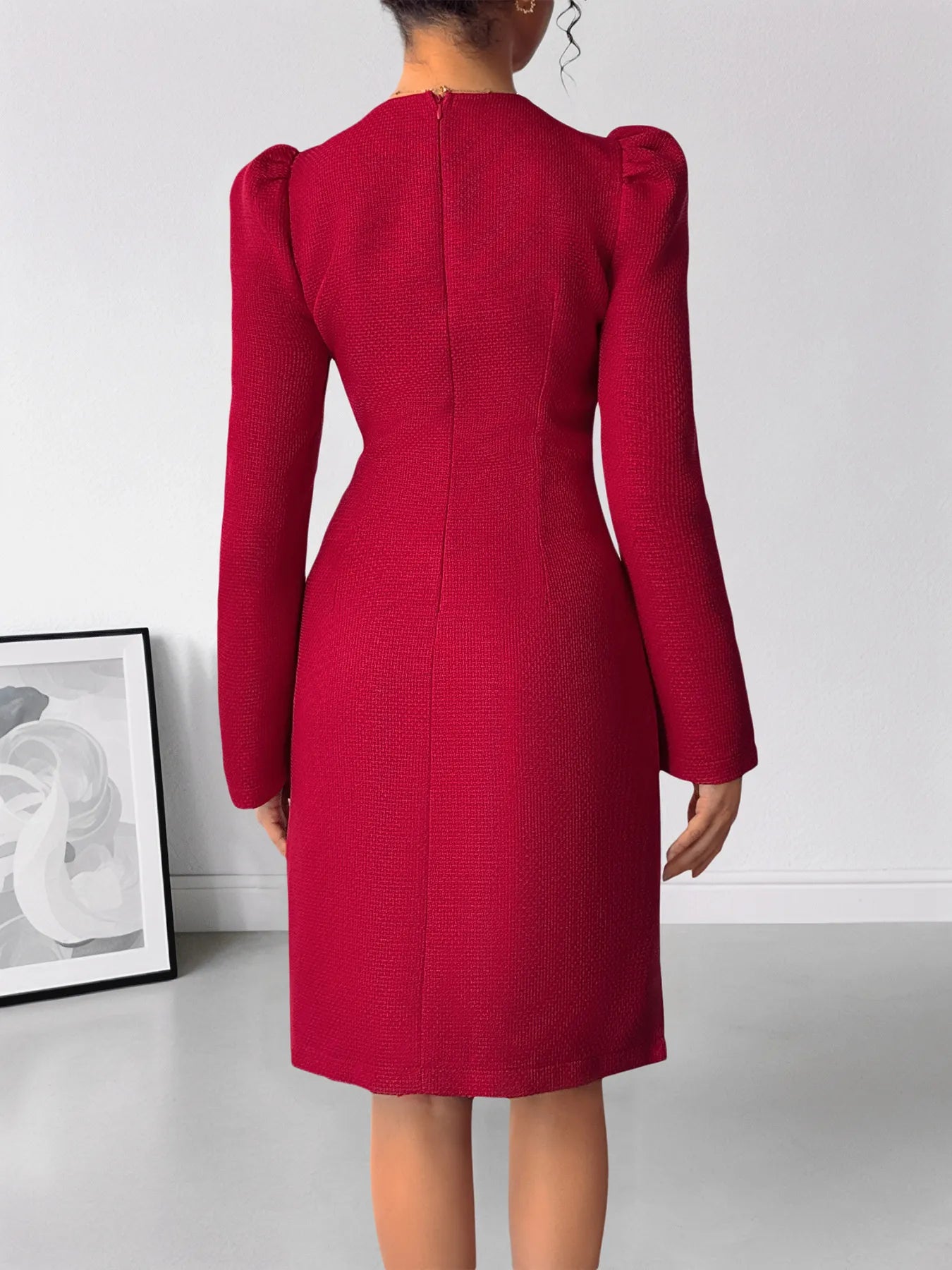 Red dress with puff sleeves on a plain background