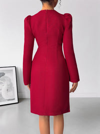 Red dress with puff sleeves on a plain background