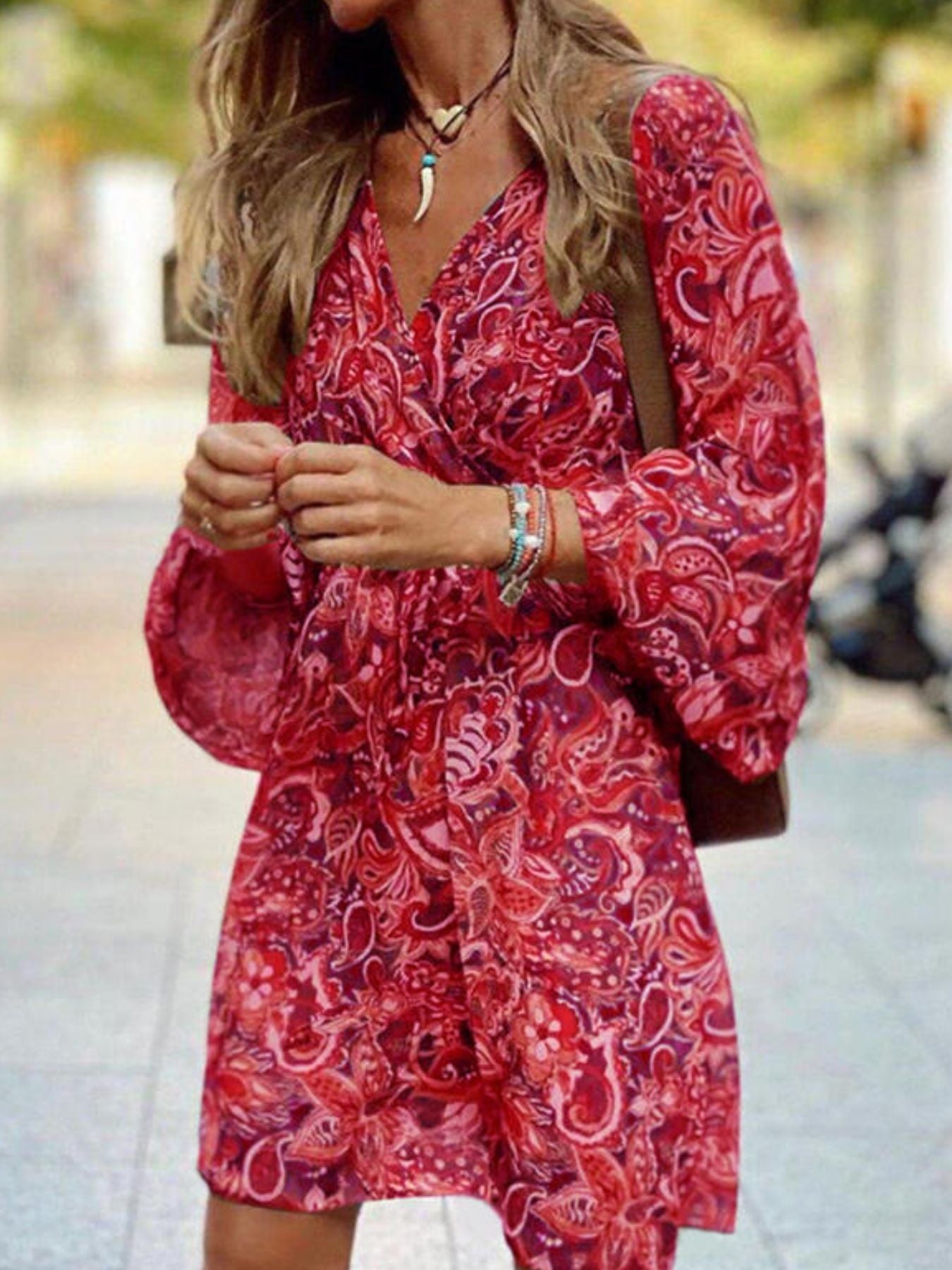 Woman wearing a red patterned dress outdoors