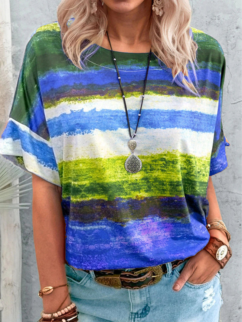 Person wearing a colorful striped shirt with a neutral background
