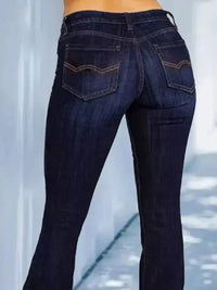 Dark blue jeans being worn, showing a blurred background