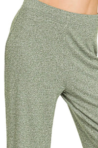 Green leggings with a textured pattern on a white background