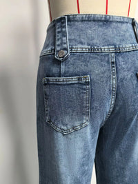 Blue jeans on a mannequin with a plain background