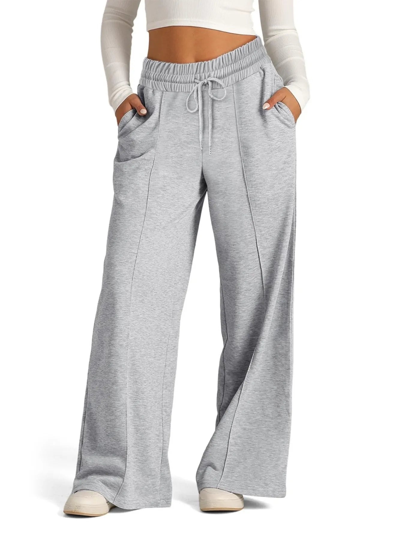 Gray sweatpants worn by a person on a white background