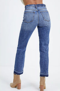 Blue jeans worn by a person on a white background