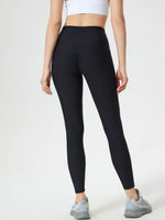 Person wearing black leggings on a white background
