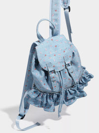 Light blue denim backpack with ruffles on a white background