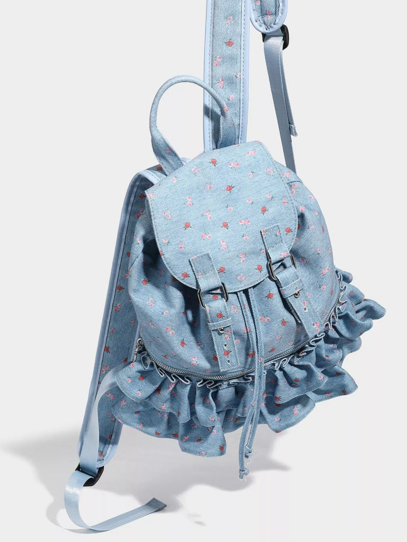 Light blue denim backpack with ruffles on a white background