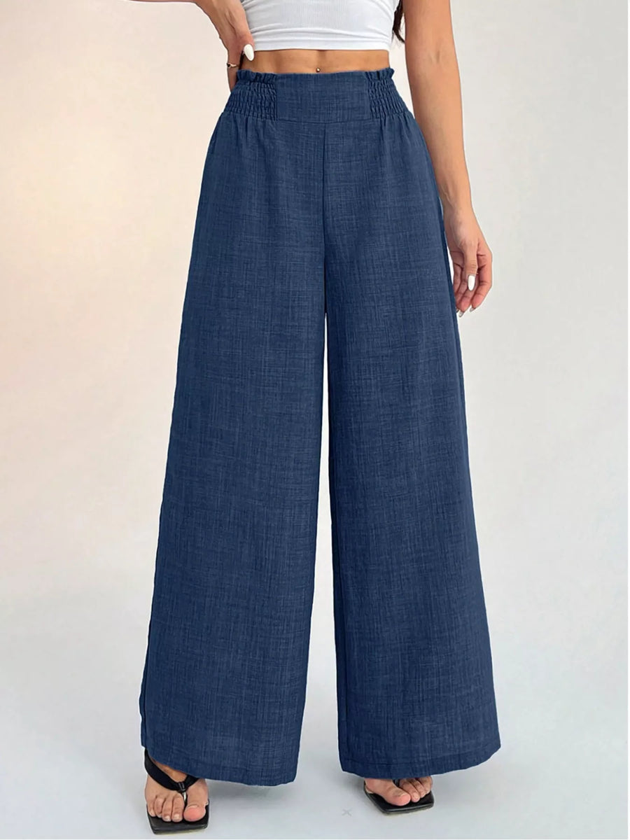 Blue wide-leg pants worn by a person on a white background