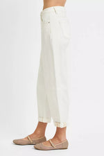 White pants worn by a person on a white background