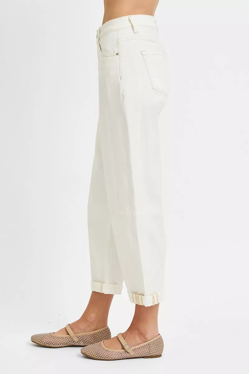 White pants worn by a person on a white background
