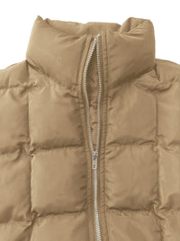 Close-up of a beige puffer vest with a zipper on a white background