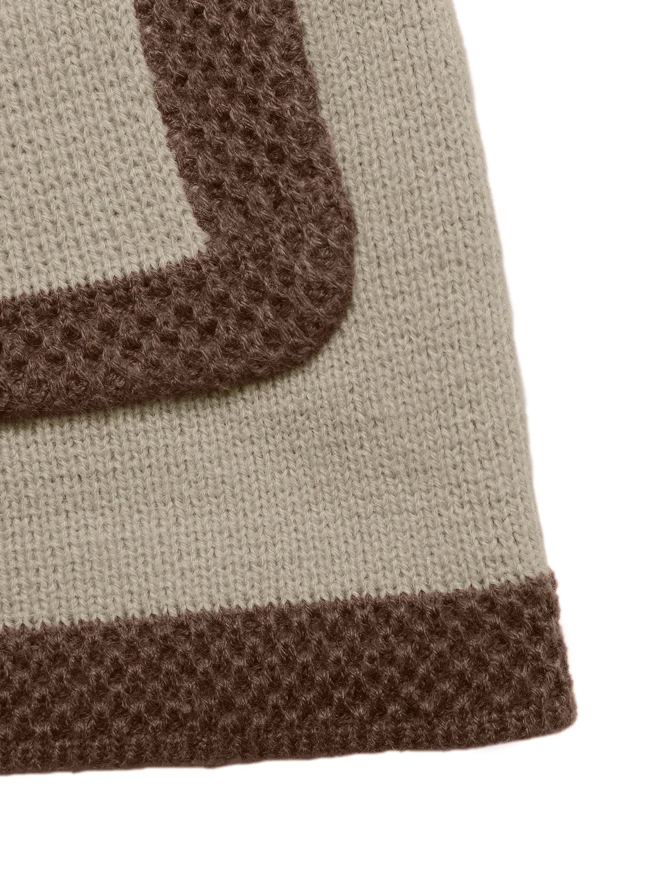 Close-up of a beige and brown textured fabric corner